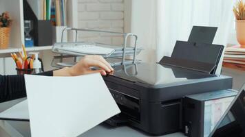 Organizing office tasks with a multi-functional printer in a bright home workspace during afternoon hours video