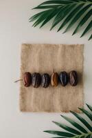 Date palm leaves and dates on a table photo