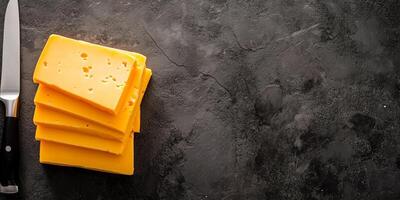 Close-up of cheddar cheese slices stacked neatly on flat surface with knife, culinary photography photo