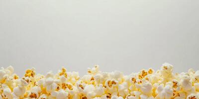 Piled buttered popcorn with popped kernels on a plain background, food photography photo