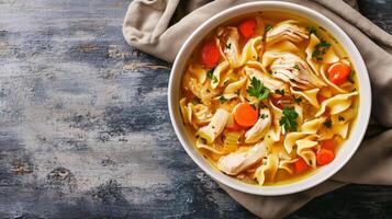 Chicken noodle soup in a dish with visible chicken, noodles, and vegetables, culinary photography photo