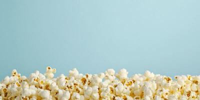 Piled buttered popcorn with popped kernels on a plain background, photorealistic food photo