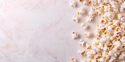 Buttered popcorn scattered on a flat surface with popped kernels visible, food setting photo