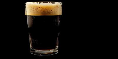 Clear glass of stout beer with visible layers of dark liquid and foam, food photography photo