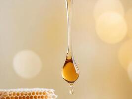 Honey is dripping from a honeycomb with a golden light background. photo
