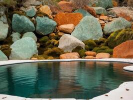 Tranquil natural pool surrounded by vibrant rocks and mossy stone formations. photo