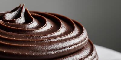 close up image of dark smooth surface chocolate frosting. photo