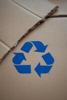 recycling symbol on a crumbled cardboard. photo