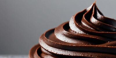 close up image of dark smooth surface chocolate frosting. photo