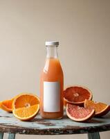 Refreshing grapefruit juice bottle with freshly sliced citrus fruits on wooden table. photo