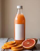 Refreshing grapefruit juice bottle with freshly sliced citrus fruits on wooden table. photo
