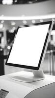 Blank digital monitor on a white surface, soft indoor lighting and blurred background Vertical Mobile Wallpaper photo