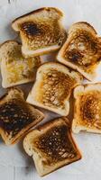 Slices of toasted bread arranged casually, golden brown with slight charred spots Vertical Mobile Wallpaper photo