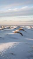 Snow covered dunes stretch to the horizon with light and shadow playing across Vertical Mobile Wallpaper photo
