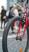 Bicycle tire close up, red frame and blurred urban background emphasize dynamic scene Vertical Mobile Wallpaper photo