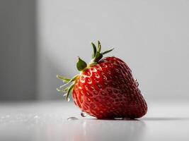 A close up of a red strawberry with a few drops of water on it. photo
