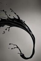bold black liquid splash swirling gracefully creating striking visual impact. photo