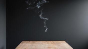 empty wooden table with smoke float up on dark background. photo