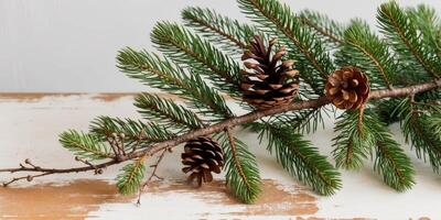 A pine tree branch with pine cones and twigs on a wooden surface. photo