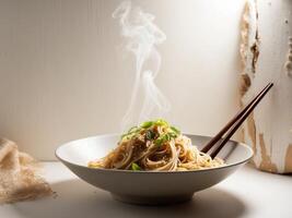 Delicious Bowl of Noodles With Green Onions and Sesame Served With Chopsticks in a Cozy Setting. photo