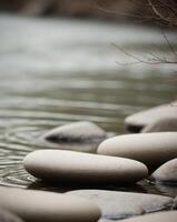 Rocks in River Smooth and Weathered Close up of rocks in a river. photo
