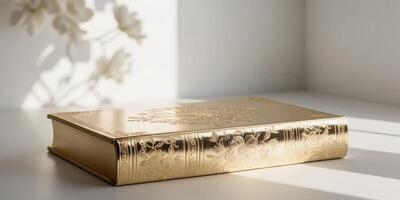 A gold leafed book with a floral design on the cover. photo