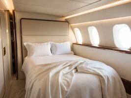 Empty double bed with white sheets is ready for a passenger in a private jet suite. photo
