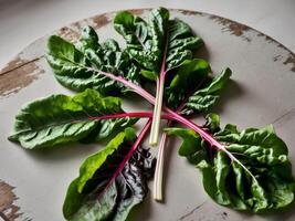 Close up image of fresh chard leaves on wooden table. photo