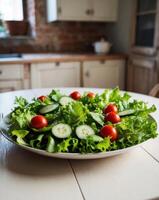 Close up of fresh green salad on light table with rustic kitchen background Healthy and easy meal concept. photo