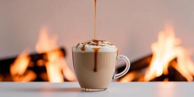 Caramel iced latte with a drizzle of caramel on top bonfire background. photo