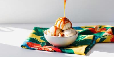 Banana ice cream bowl with caramel on a tropical themed fabric. photo
