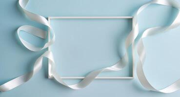 Wavy Satin Ribbons Creating a Frame on a Blue Background. photo