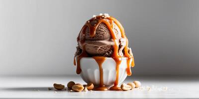 Chocolate ice cream with caramel sauce and salted peanuts. photo