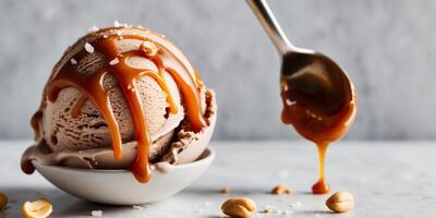 Chocolate ice cream with caramel sauce and salted peanuts. photo