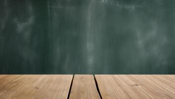 background of green chalkboard and wooden table with copy space. photo