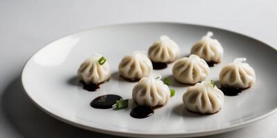 Cute dumplings with soy sauce splashed on top. photo