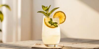 Refreshing and Inviting Glass of Sparkling Lemonade with Fresh Mint Leaves and Slices of Citrus Fruit on a Rustic Wooden Table Bathed in Warm Sunlight. photo