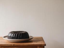 Elegant Black Sesame Chiffon Cake on Rustic Table. photo