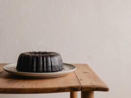 Elegant Black Sesame Chiffon Cake on Rustic Table. photo