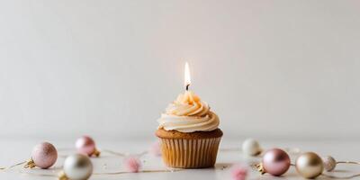 Festive Cupcake with Candle Surrounded by Decorations. photo