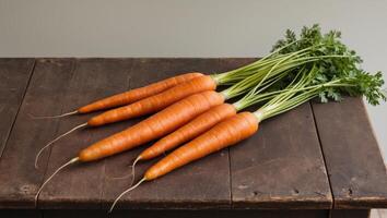 Group of carrots top view lined up on old rustic brown wooden table. photo