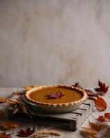Rustic autumn scene with pumpkin pie and fall leaves. photo
