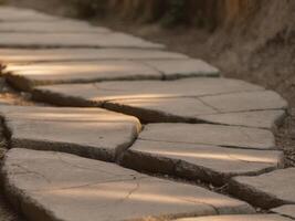 A stone walkway with a light shining through the cracks in it. photo