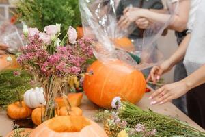 Creating a floral composition in a pumpkin. Making decor with your own hands. photo