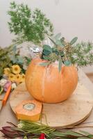 Creating a floral composition in a pumpkin. Making decor with your own hands. photo