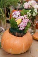 Creating a floral composition in a pumpkin. Making decor with your own hands. photo