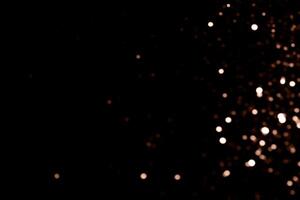 Blurry garland lights on a dark background. Festive Christmas and New Year background. Soft focus. Image toned in color of 2025 year - Mocha Mousse photo