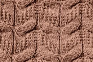 Beautiful handmade knitted repeating pattern. Demonstrating the colors of 2025 - Mocha Mousse photo