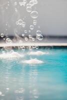 Bubbles in a pool with water splashing photo
