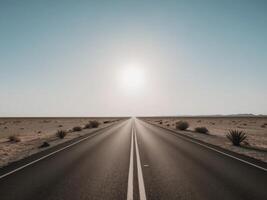 An empty road in the desert with the sun shining photo